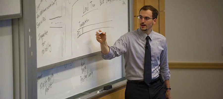 Damian Beil teaching in front of a whiteboard