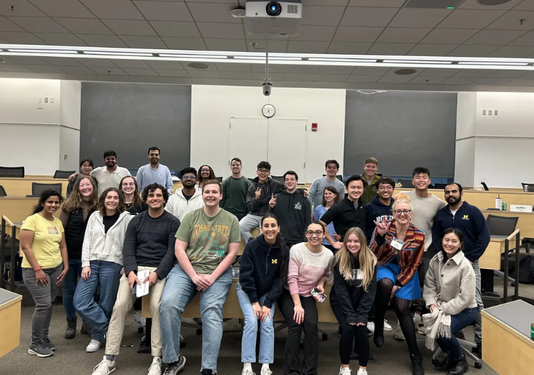 Group of students in a classroom smiling