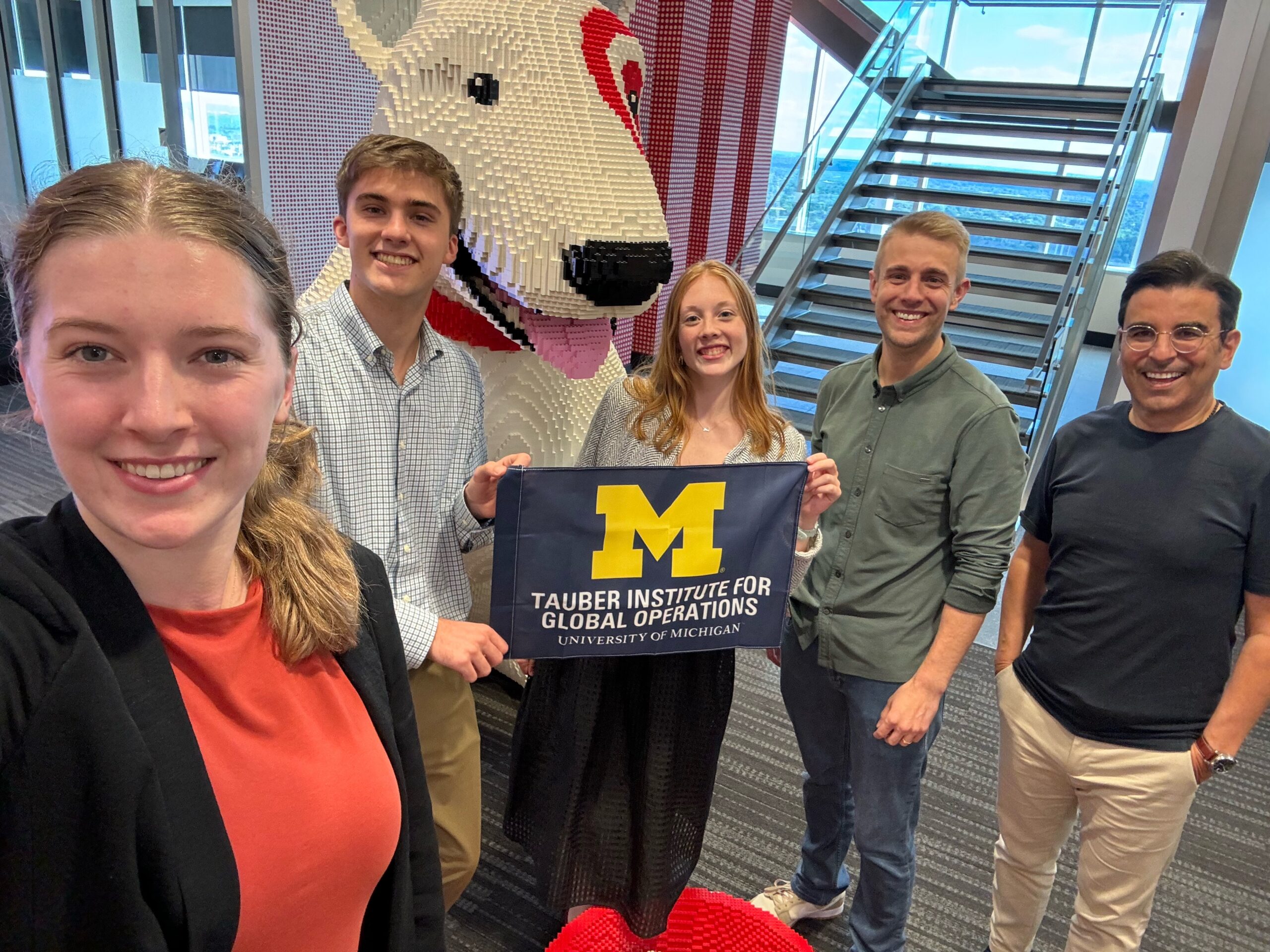 A group of Tauber students at Target during their team project posing with their industry partner