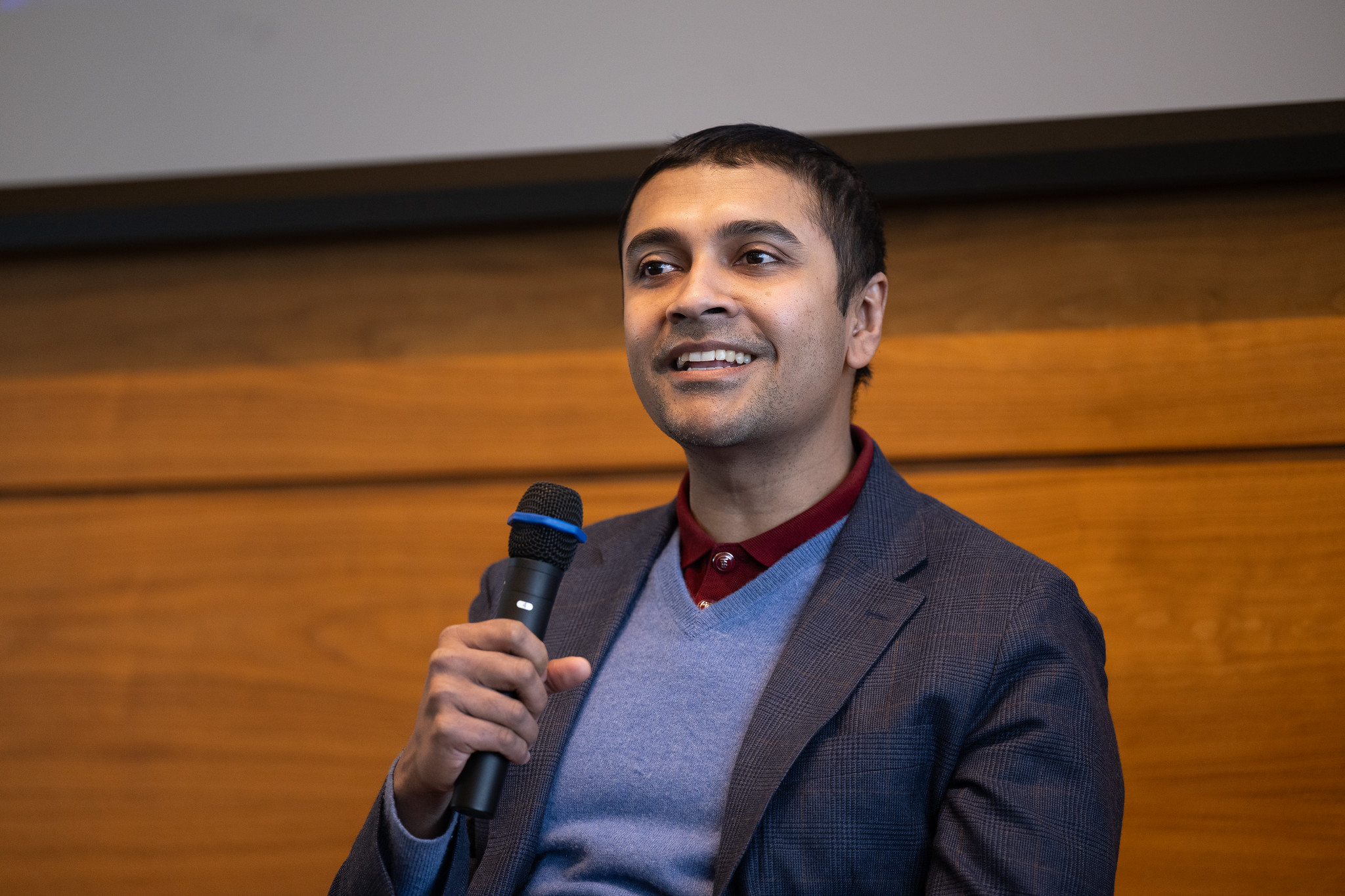 A Tauber faculty member smiling on stage at the 2026 Global Operations Conference