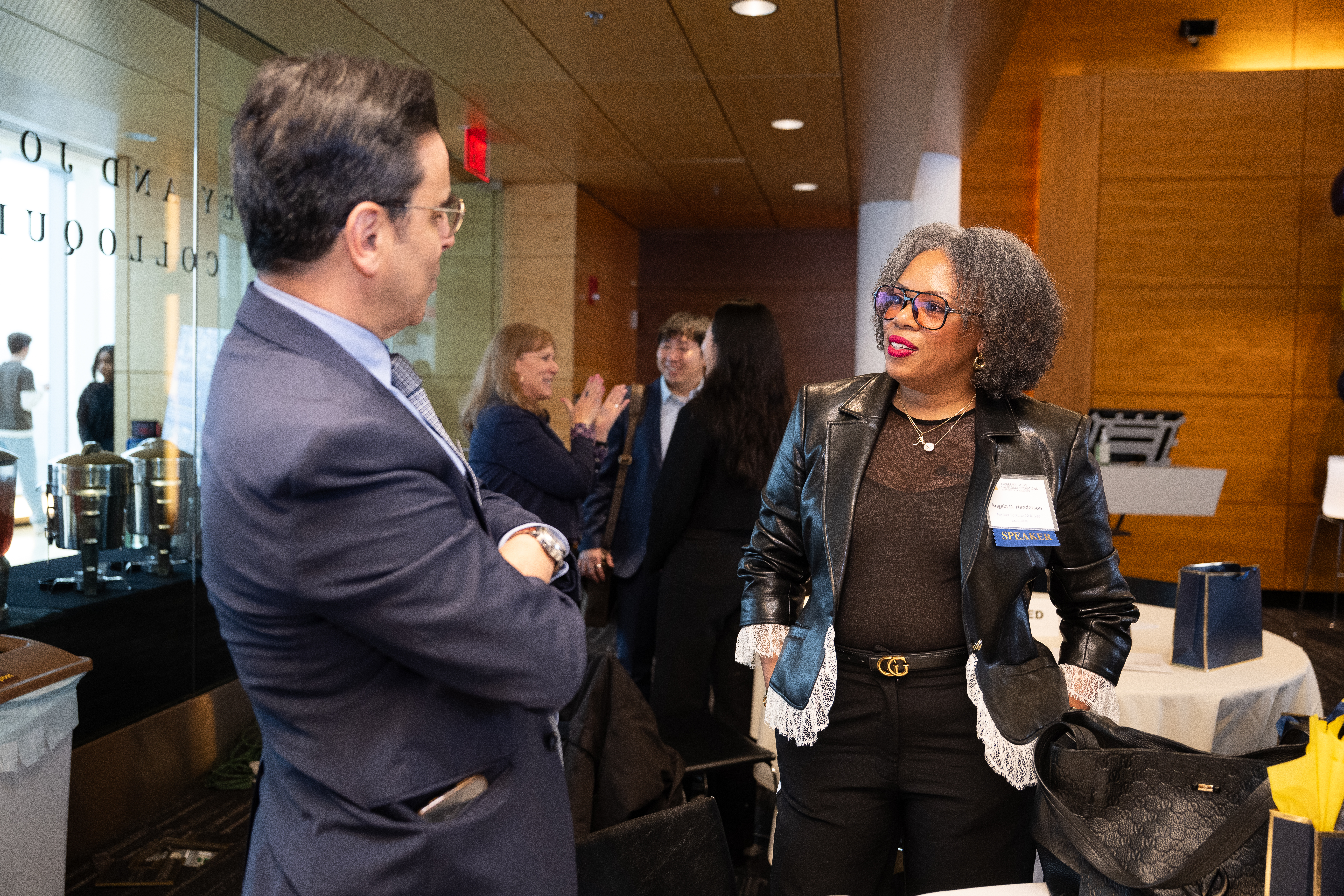 Tauber Co-director converses with panelist at GOC 2025