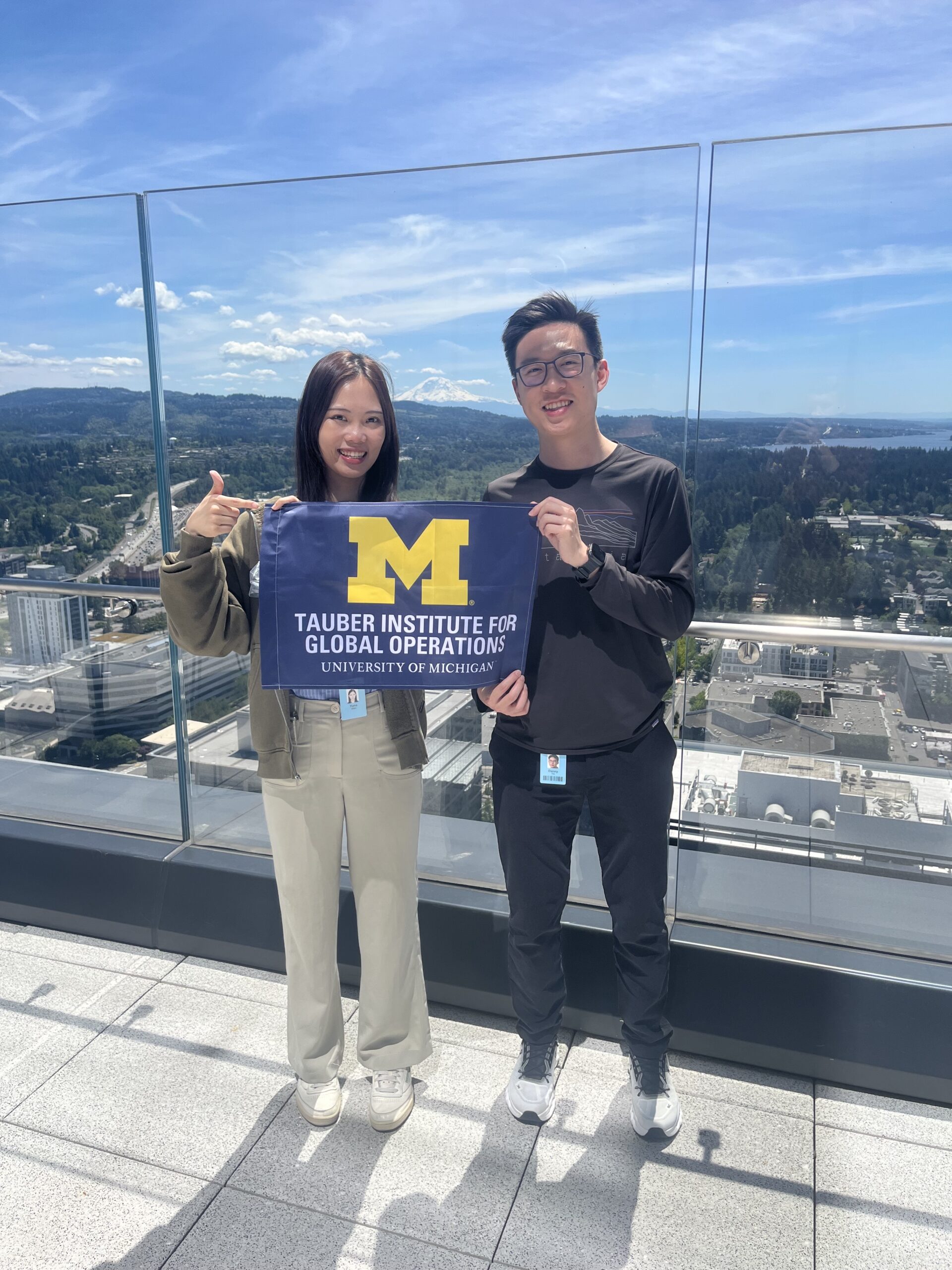 Two students pose with the Tauber flag