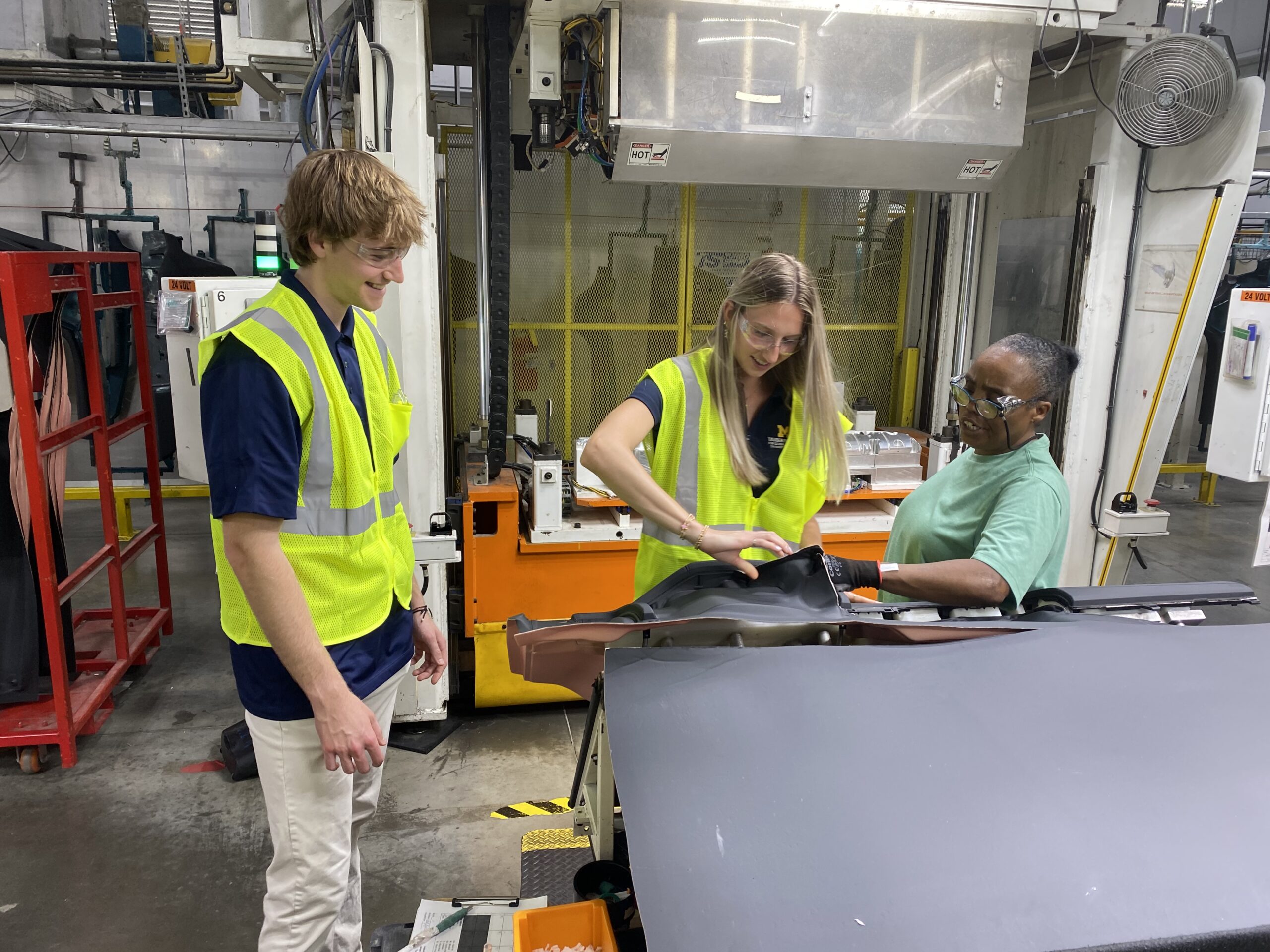 Two students working in a factory