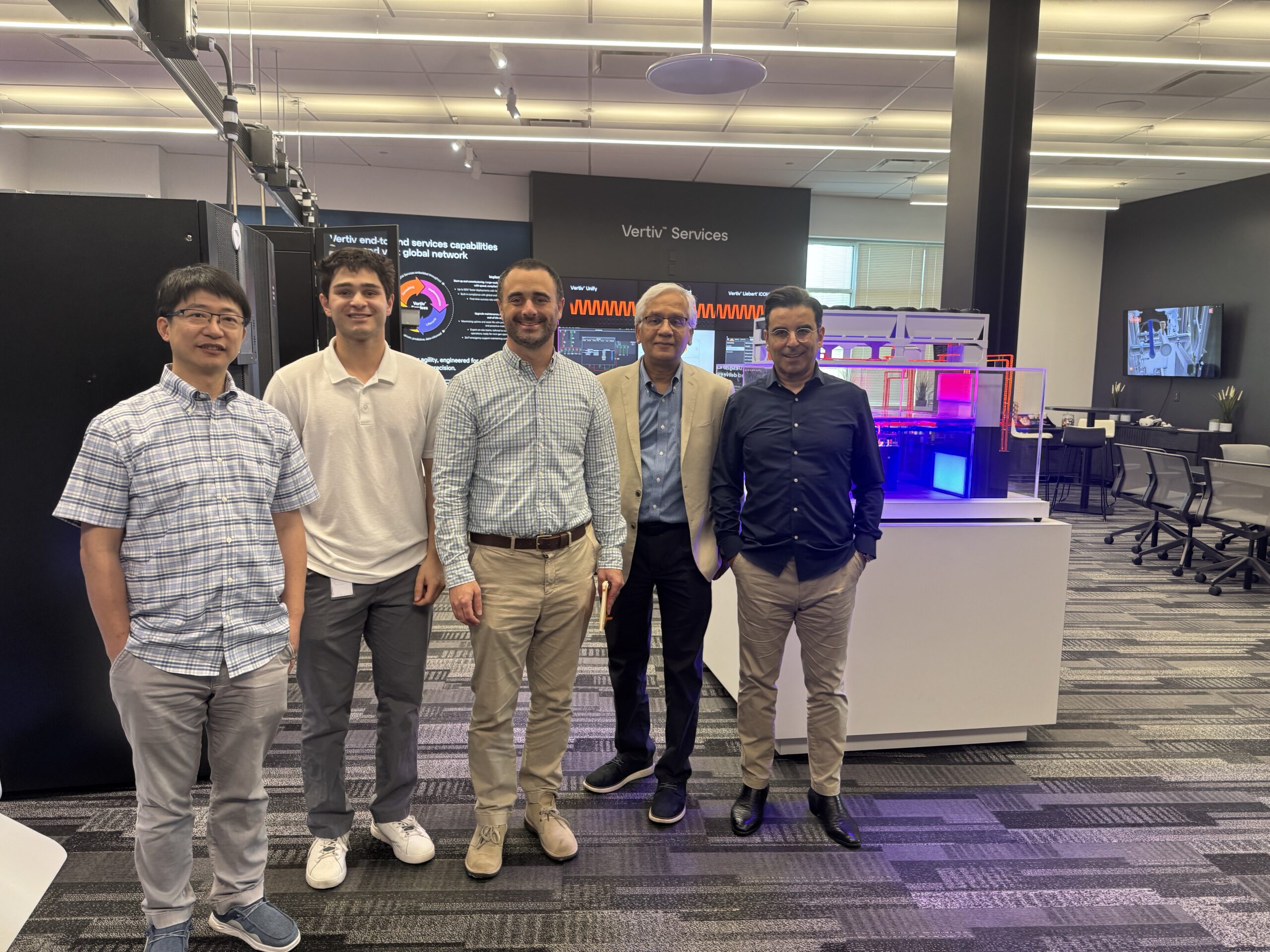 A group of people pose in the Vertiv Offices