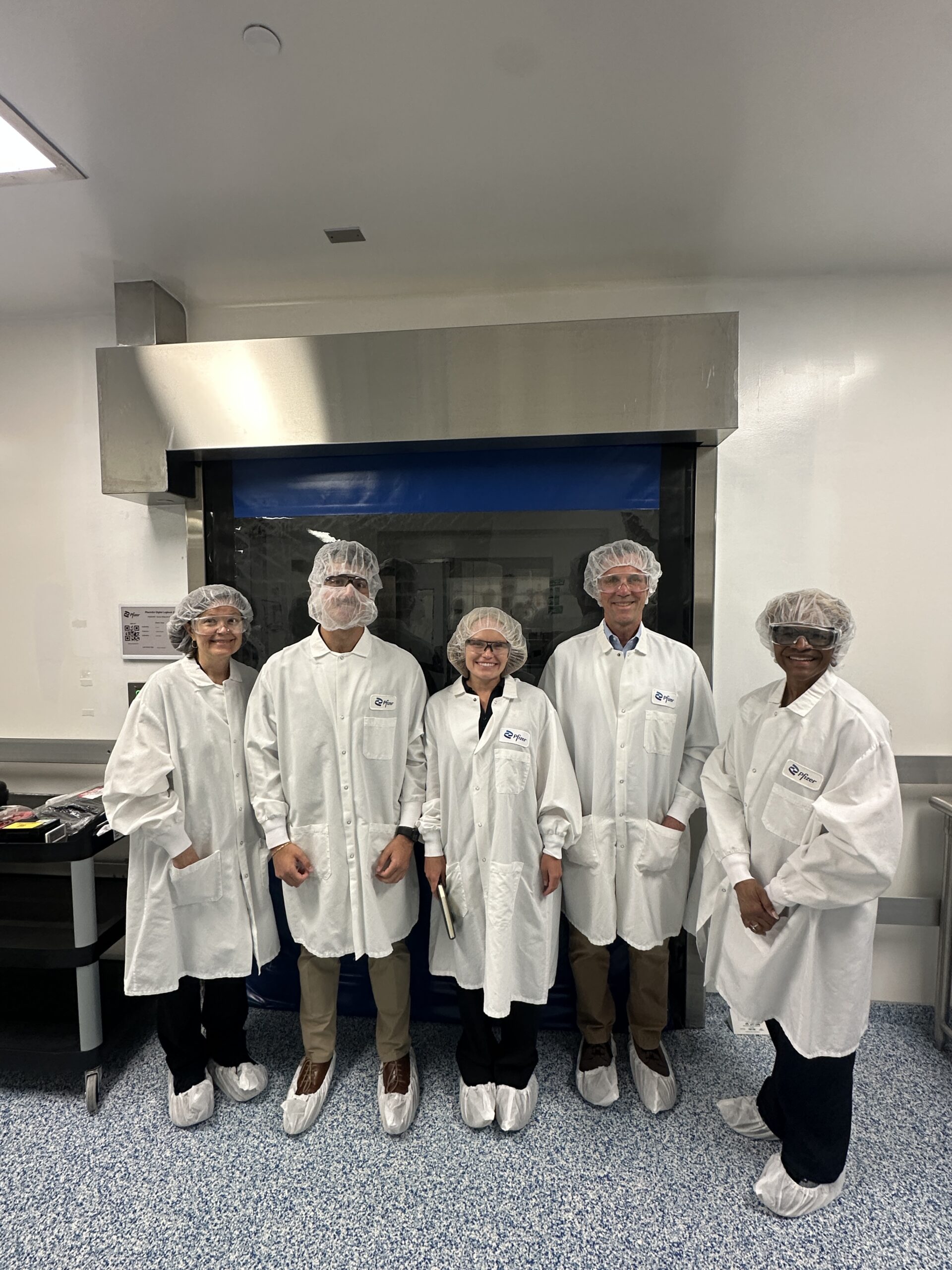 A group of people in medical scrubs pose