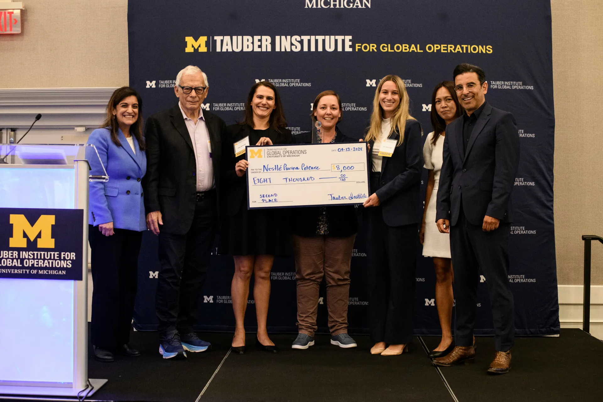2024 Spotlight! second-place winners pose with their check