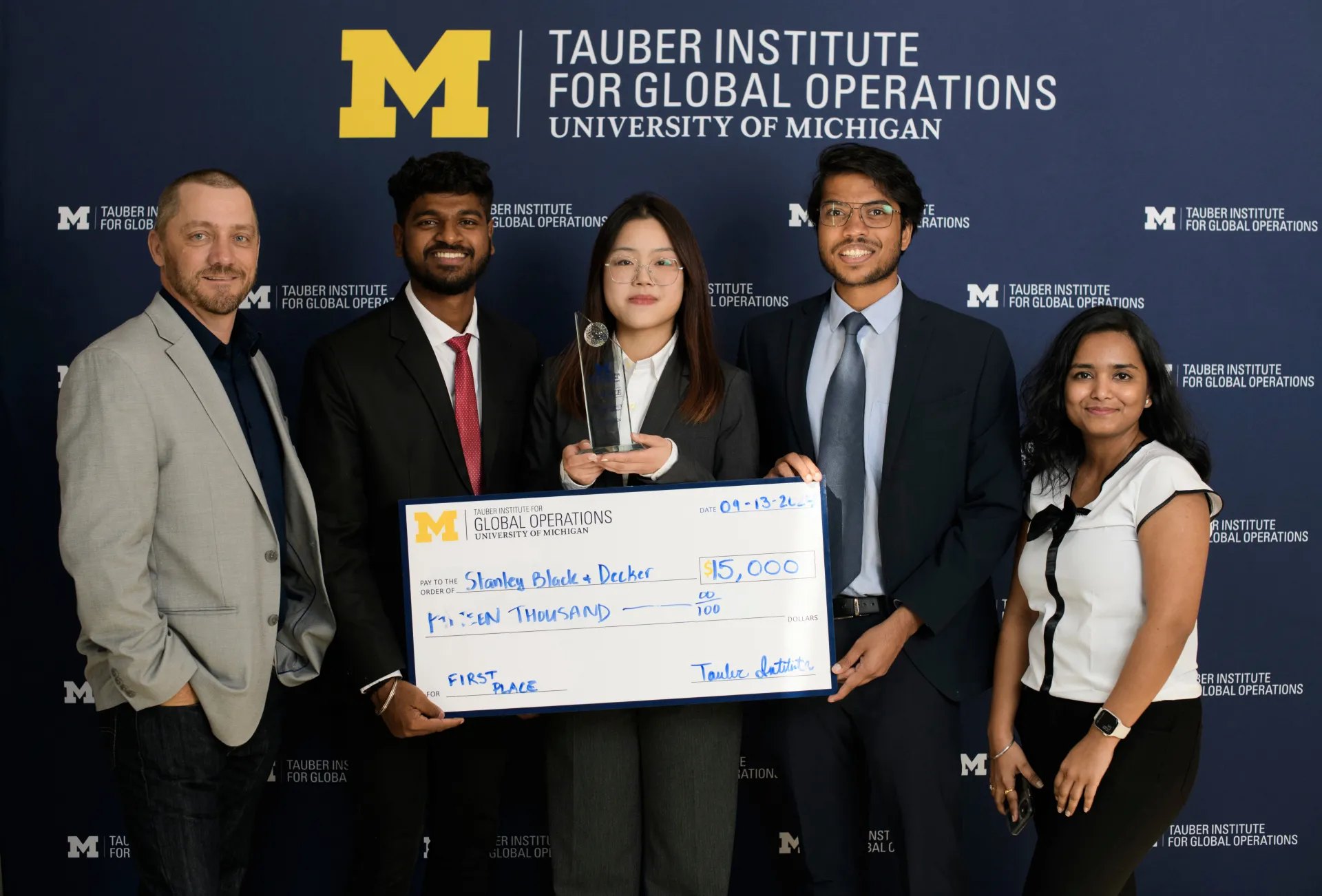 2024 Spotlight! first-place winners pose with their check